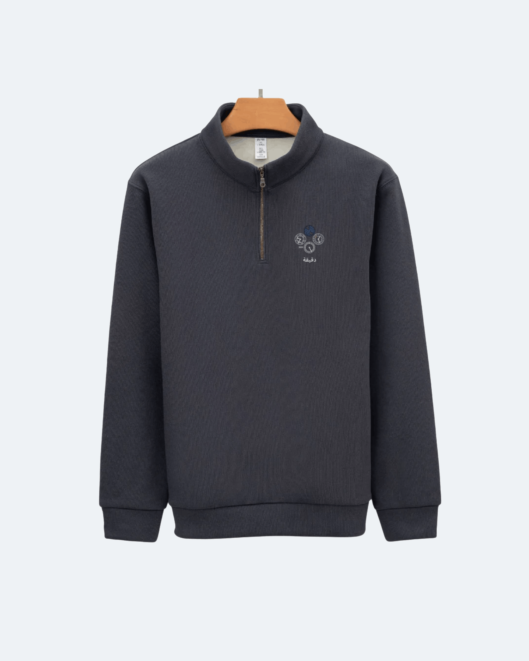 Dark gray Perpetual Flight Quarter Zip sweatshirt with a small logo on a light gray background