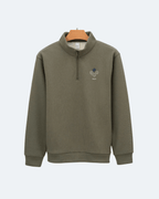 Green Perpetual Flight Quarter Zip sweatshirt with a small logo on a white background