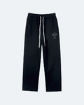 Black Perpetual Flight Trackpants with a small logo on a white background
