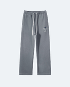 Gray Perpetual Flight Trackpants  sweatpants with a small logo on a white background
