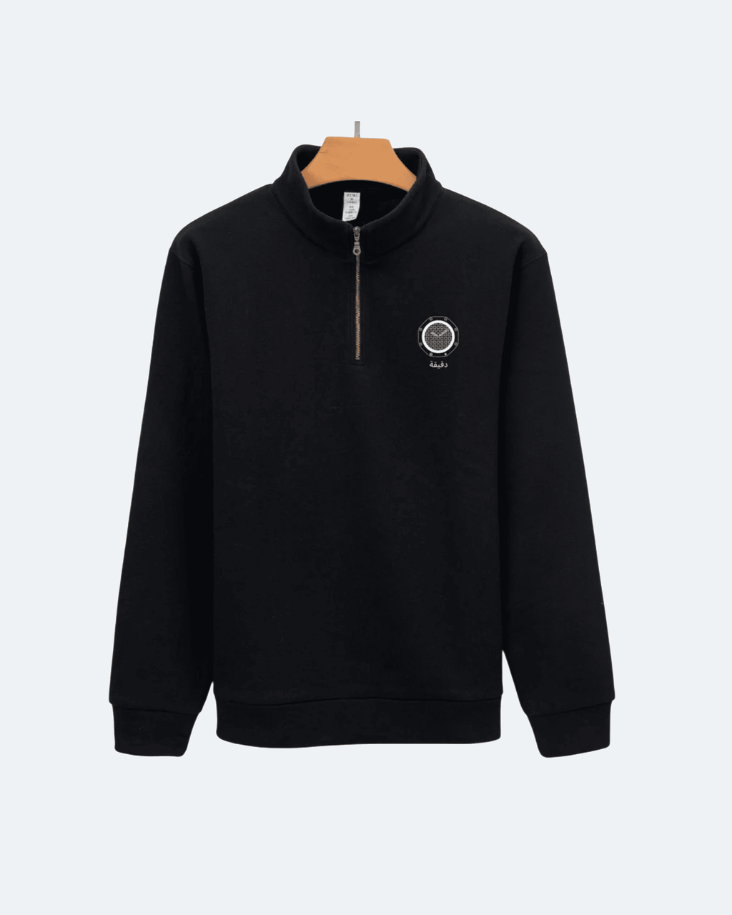 Black Royal Time Quarter Zip sweatshirt with a logo on a hanger against a white background